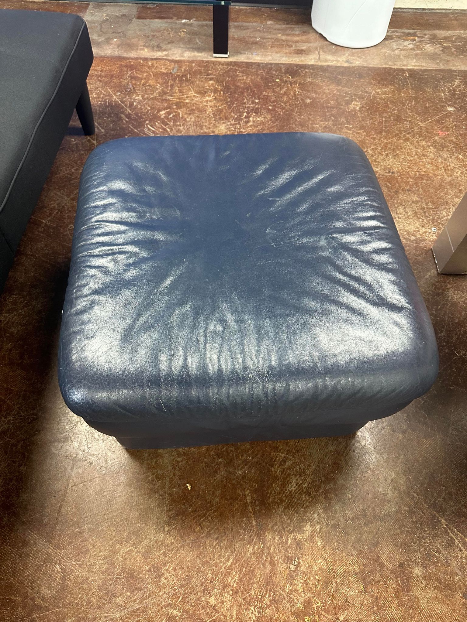 Navy Blue Leather Ottoman from the G. Huenergardt Collection.